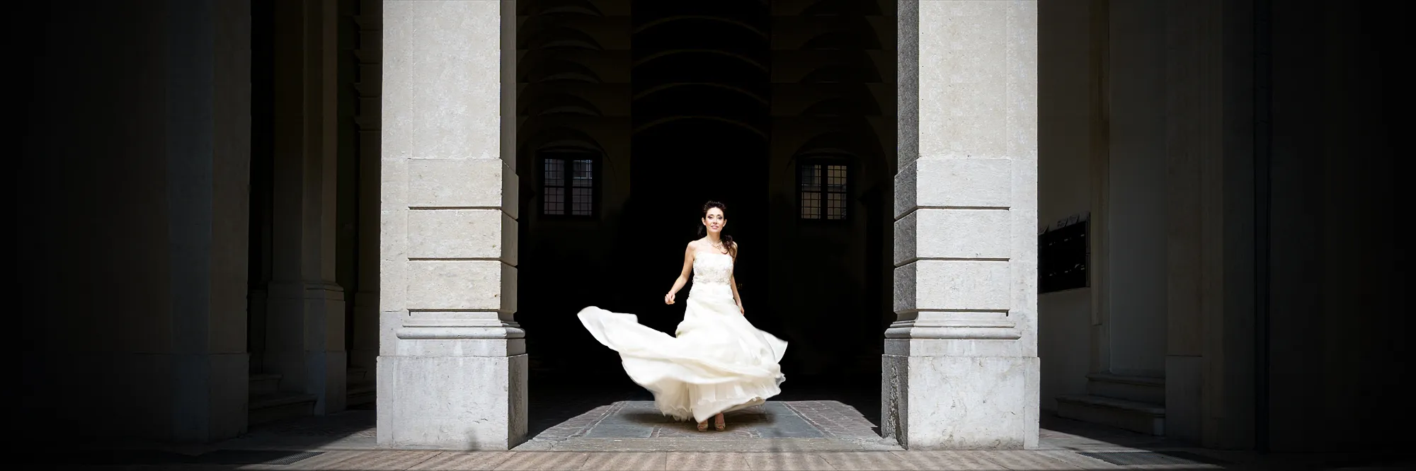 Bride twirling in a sunlit Renaissance portico — oemme photography